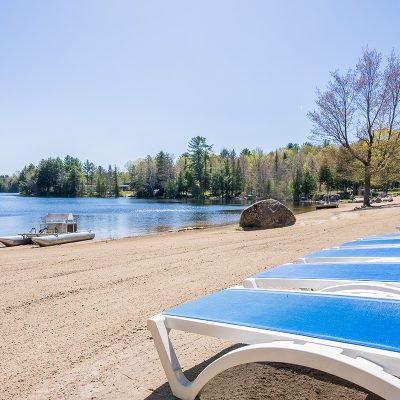 Bonnie Lake Resort | Beautiful freshly combed sandy beach, with lounge chairs overlooking the peaceful lake | Muskoka resort living