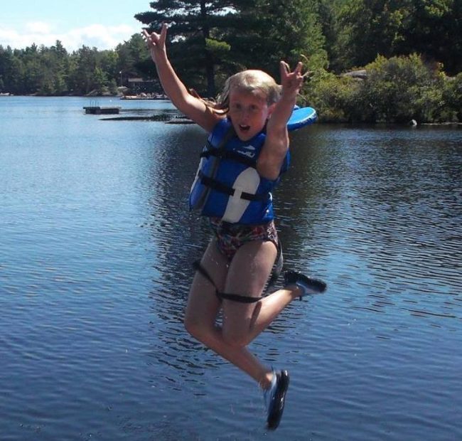 Kid jumping into the lake